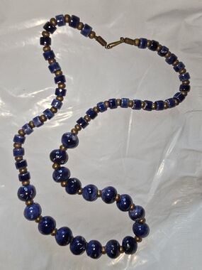 vintage bohemian necklace features cobalt blue ceramic beads with brass